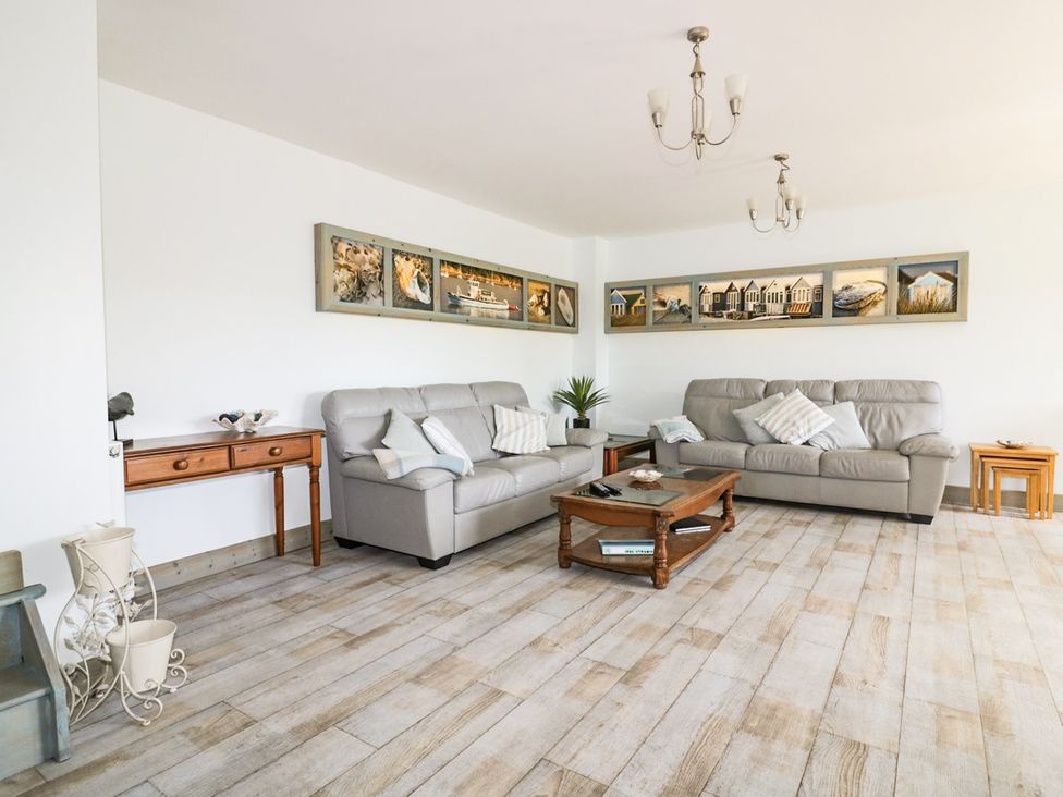 A living room with sofas and a coffee table at Squirrels Dray in Gorran Haven
