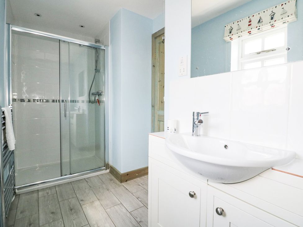 A bathroom with a shower and sink at Squirrels Dray in Gorran Haven