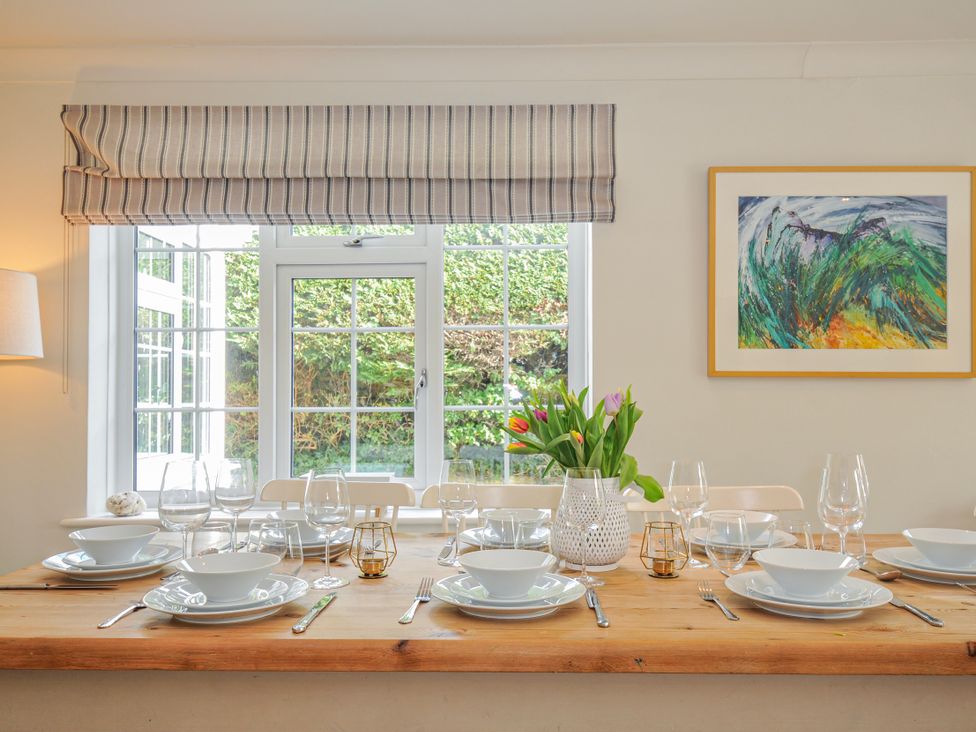 A dining room with a table set for a meal at Samphire in Rock