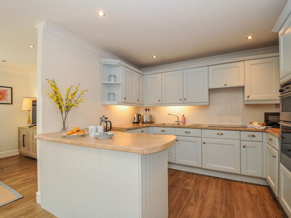 A kitchen with cabinets and appliances at Samphire in Rock