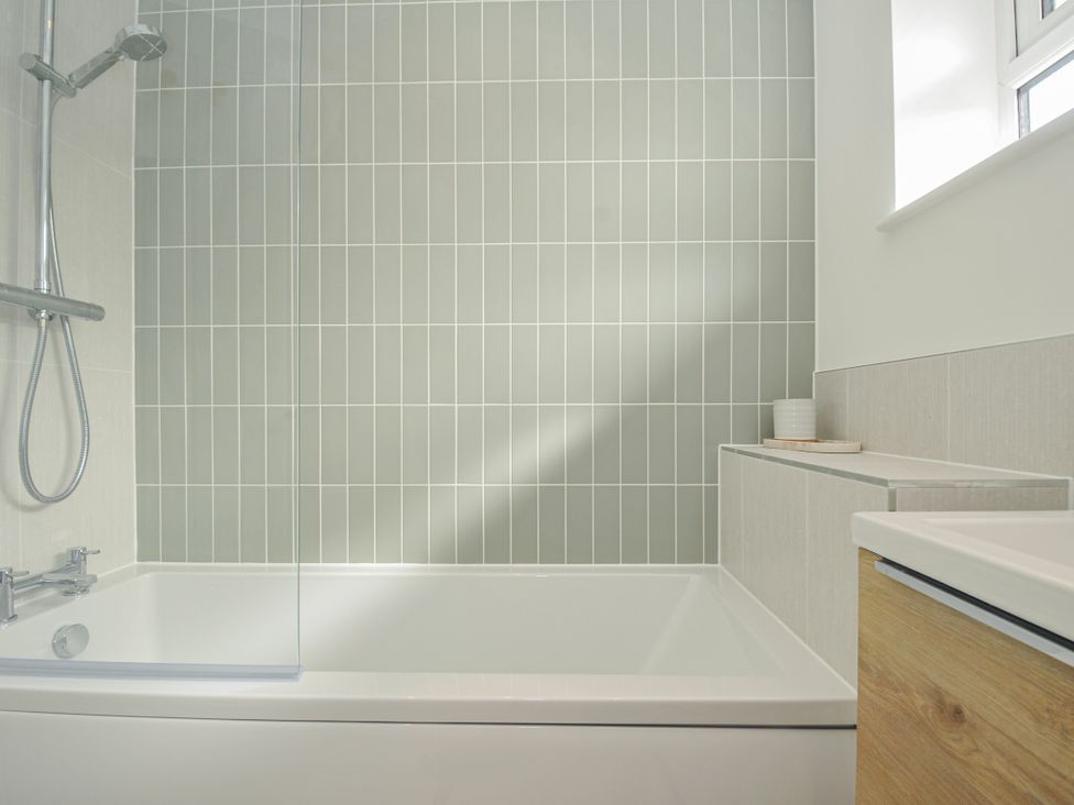 A bathroom with a bathtub and shower at Samphire in Rock