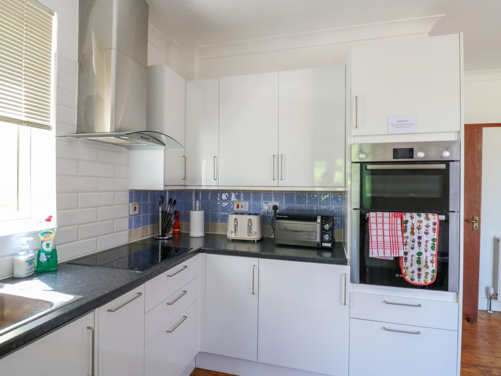 A kitchen with white cabinets and appliances at Ninety Eight Southend-On-Sea