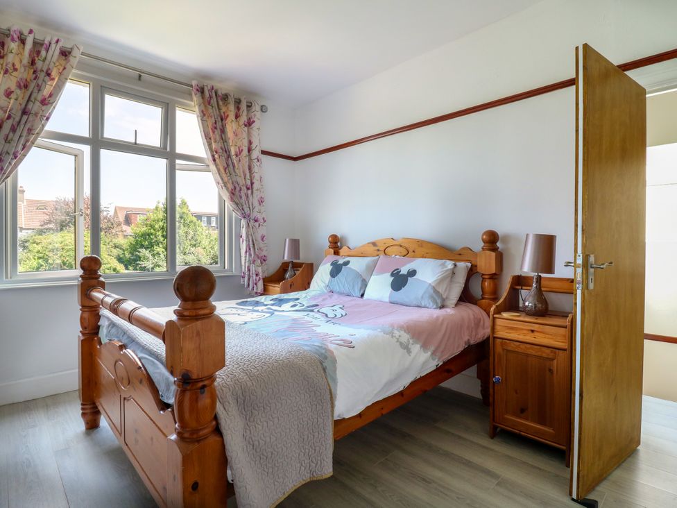 A bedroom with a bed and bedside table at Ninety Eight in Southend-On-Sea