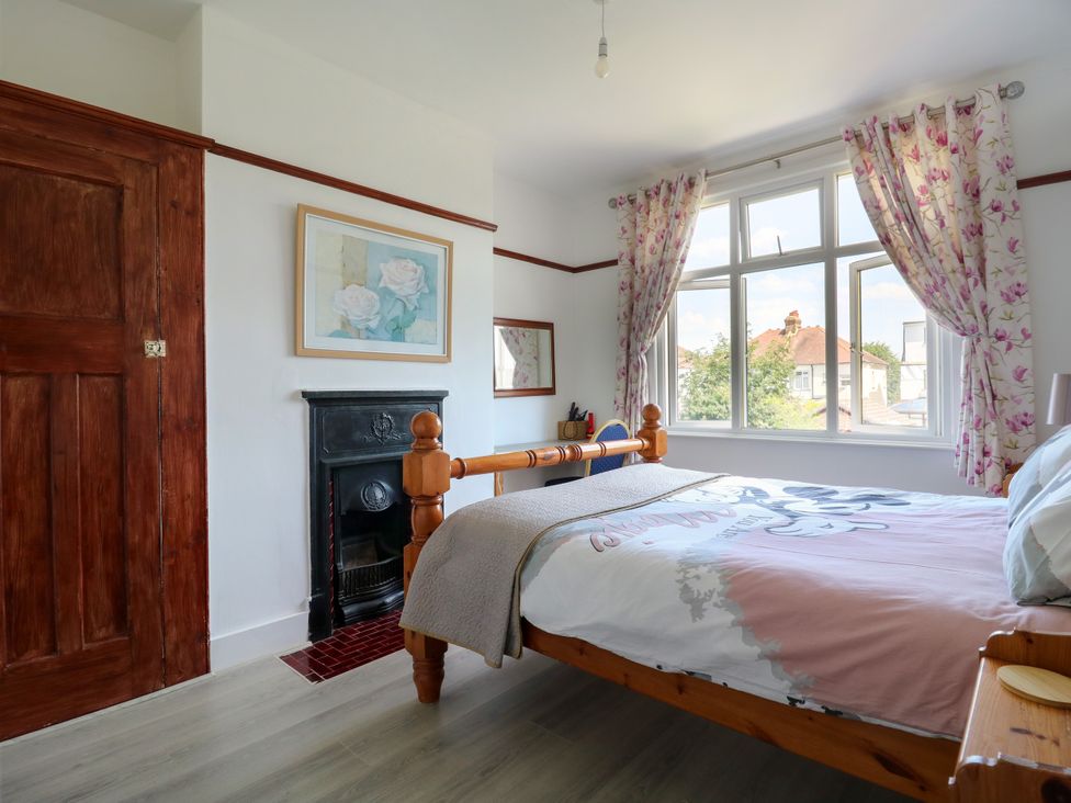 A bedroom with a bed and window at Ninety Eight Southend-On-Sea