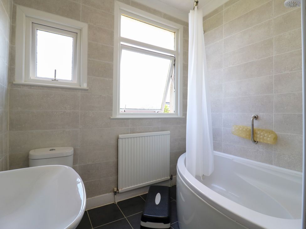 A bathroom with a bathtub and toilet at Ninety Eight Southend-On-Sea