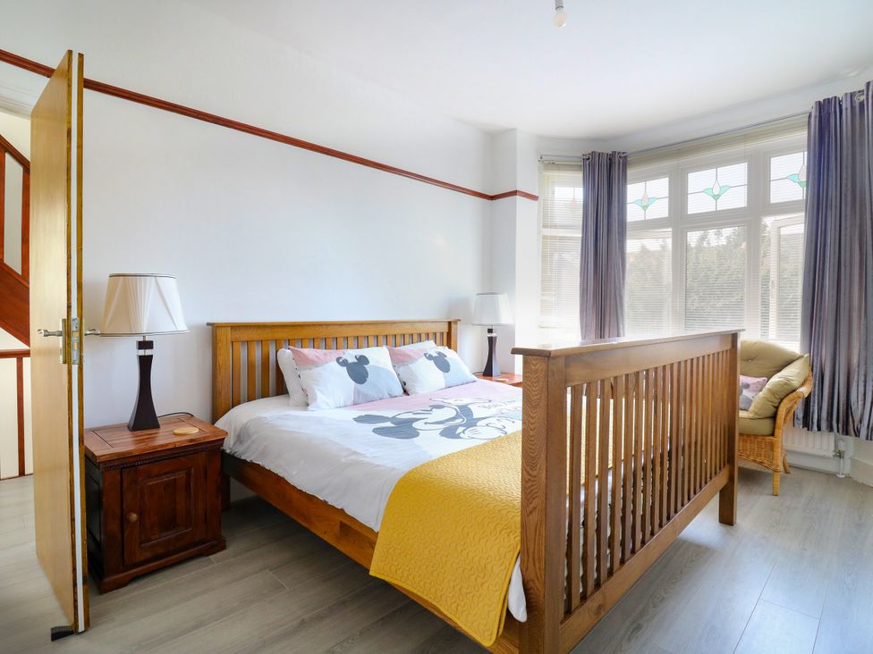 A bedroom with a bed and a chair at Ninety Eight in Southend-On-Sea