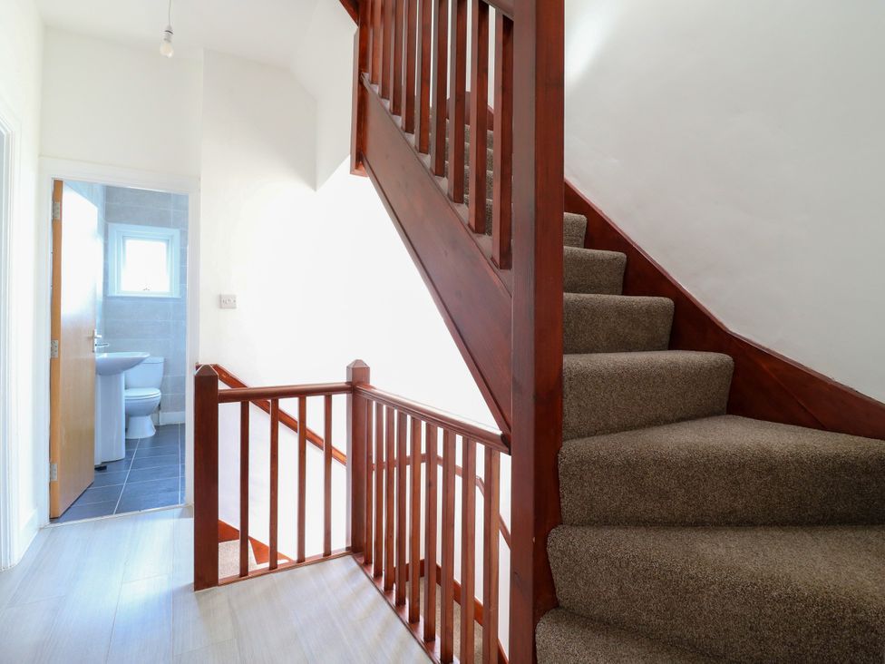 A hallway with a staircase and bathroom at Ninety Eight Southend-On-Sea
