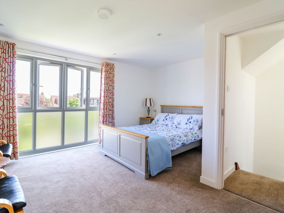 A bedroom with a bed and bedside table at Ninety Eight in Southend-On-Sea