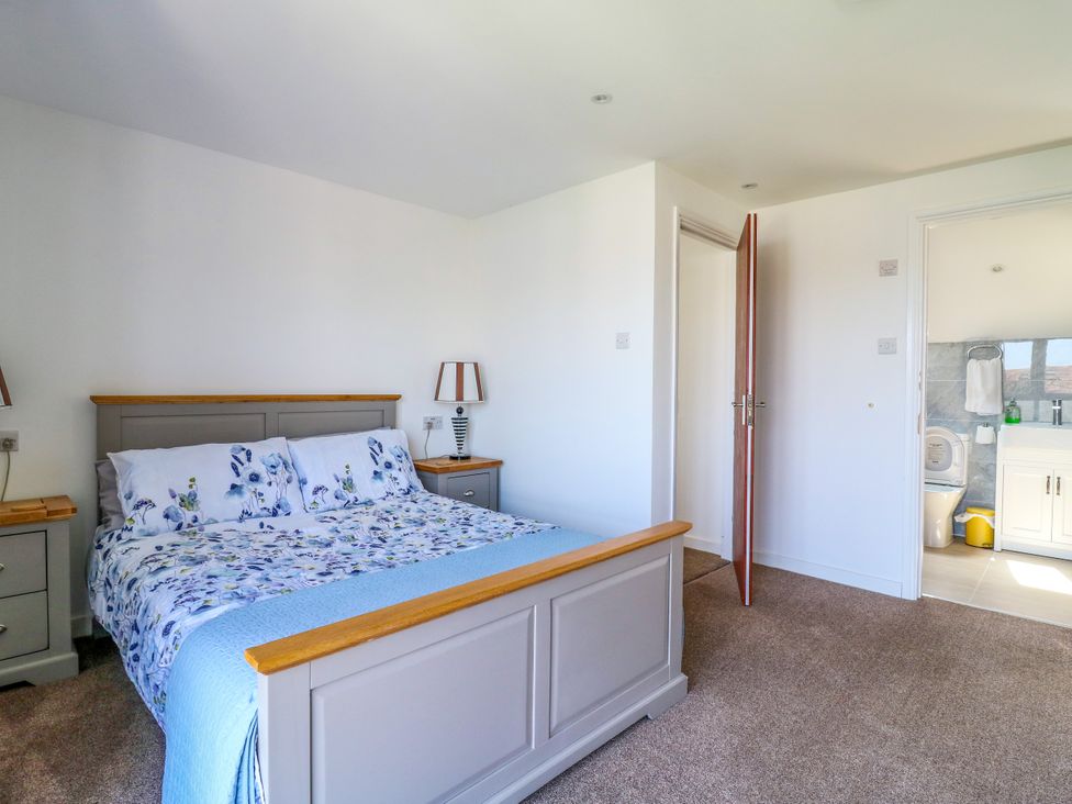 A bedroom with a bed and nightstand at Ninety Eight in Southend-On-Sea