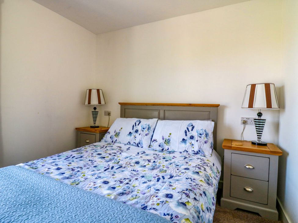 A bedroom with a bed and nightstands at Ninety Eight Southend-On-Sea