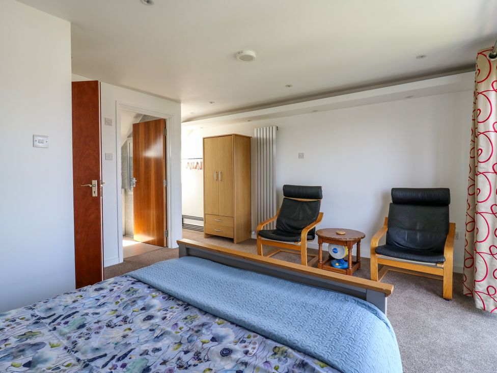 A bedroom with a bed and chairs at Ninety Eight in Southend-On-Sea
