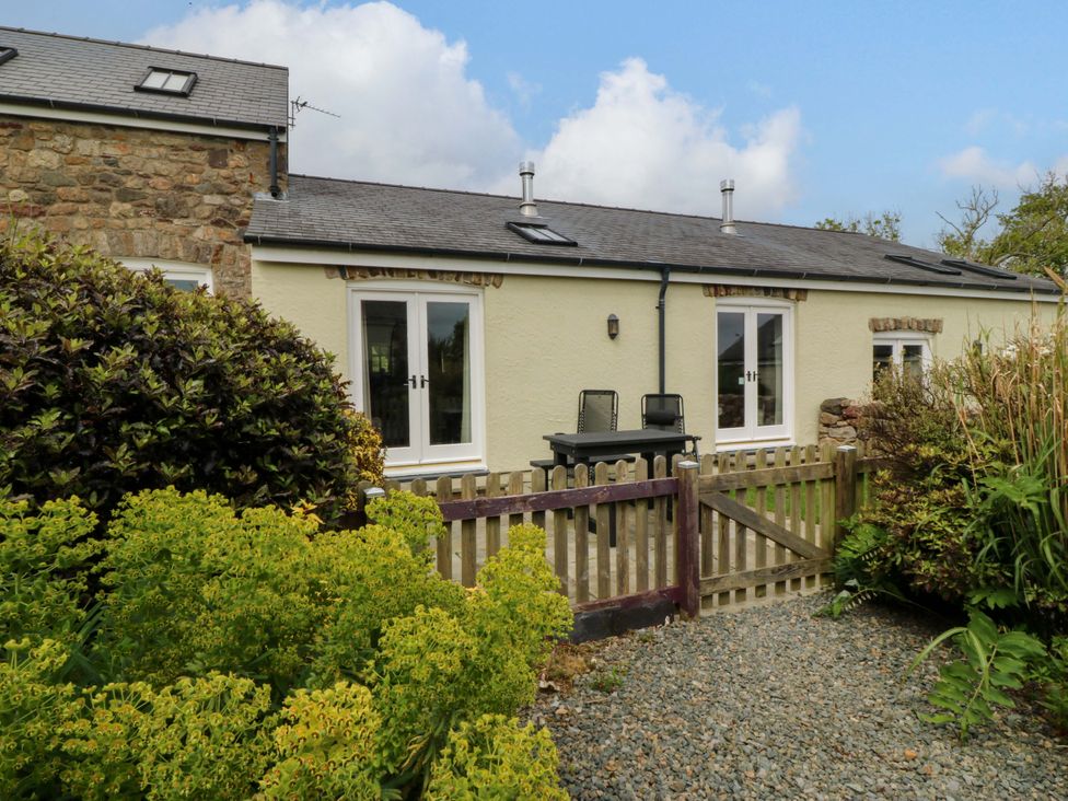 A house with a fence and garden at No 3 The Dairy Capel Coch near Llannerch-Y-Medd