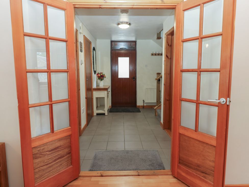 A hallway with double doors and a console table at Summerseat in Kirkby Stephen