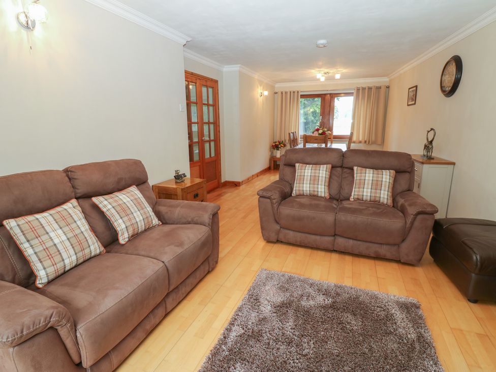 A living room with sofas and a dining area at Summerseat in Kirkby Stephen