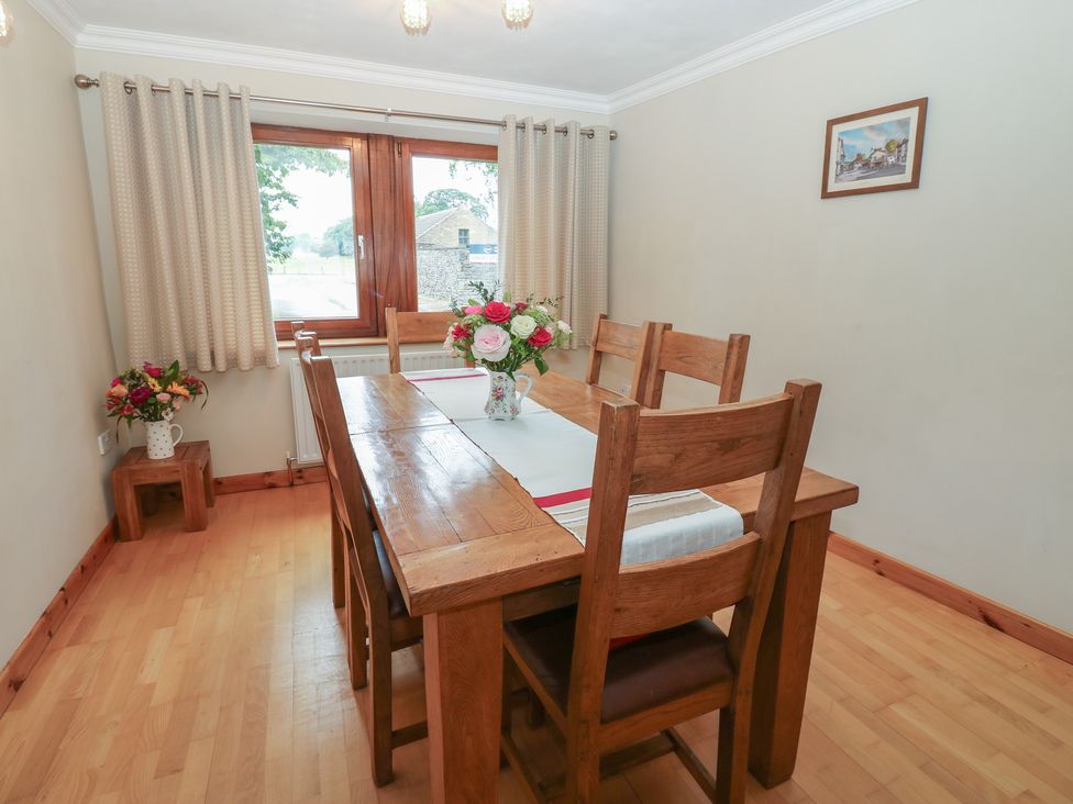 A dining room with a table and chairs at Summerseat in Kirkby Stephen