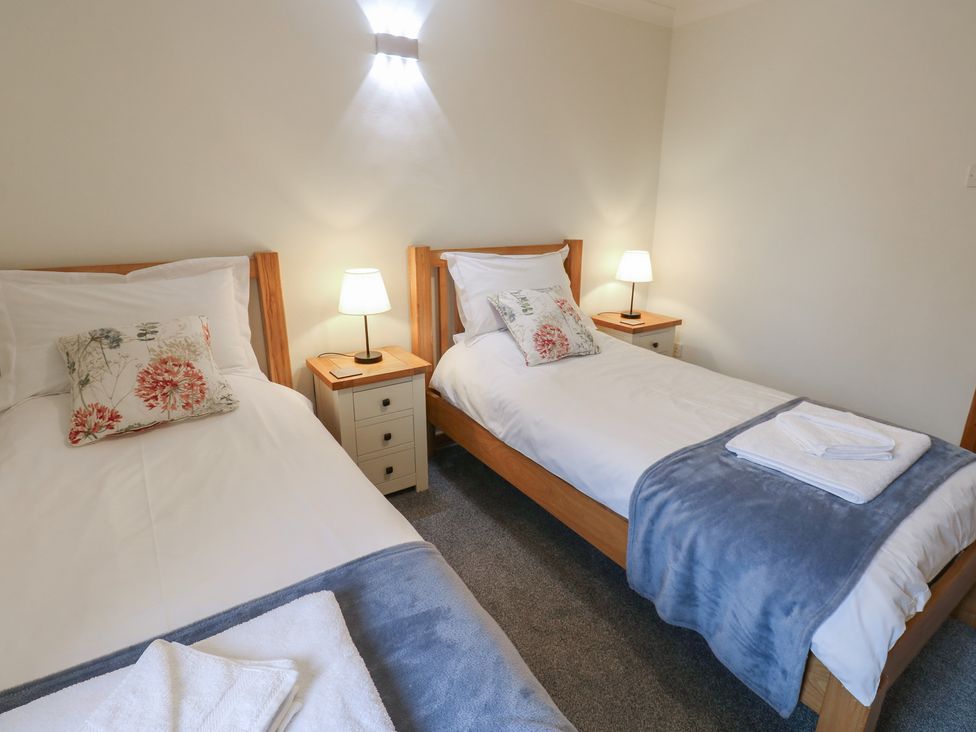 A bedroom with two single beds and bedside tables at Summerseat in Kirkby Stephen