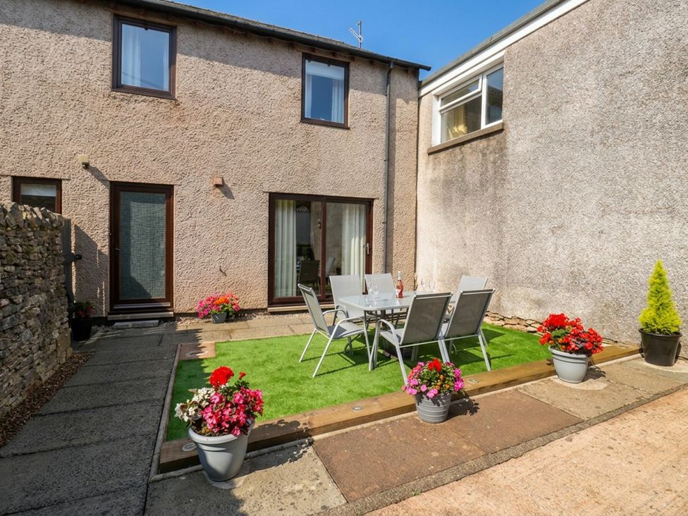 A garden area with a table and chairs at Summerseat in Kirkby Stephen