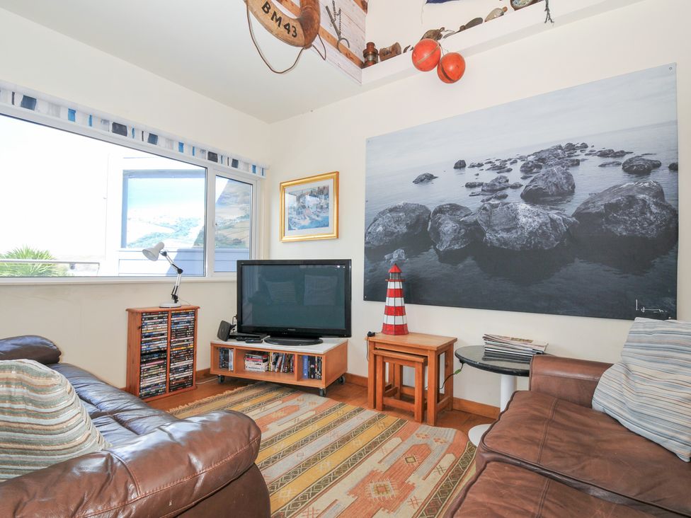 A living room with a television and sofa at Beachside in Polzeath