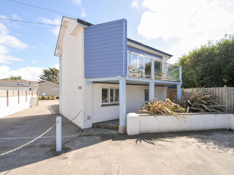 A house with a balcony and driveway at Beachside in Polzeath