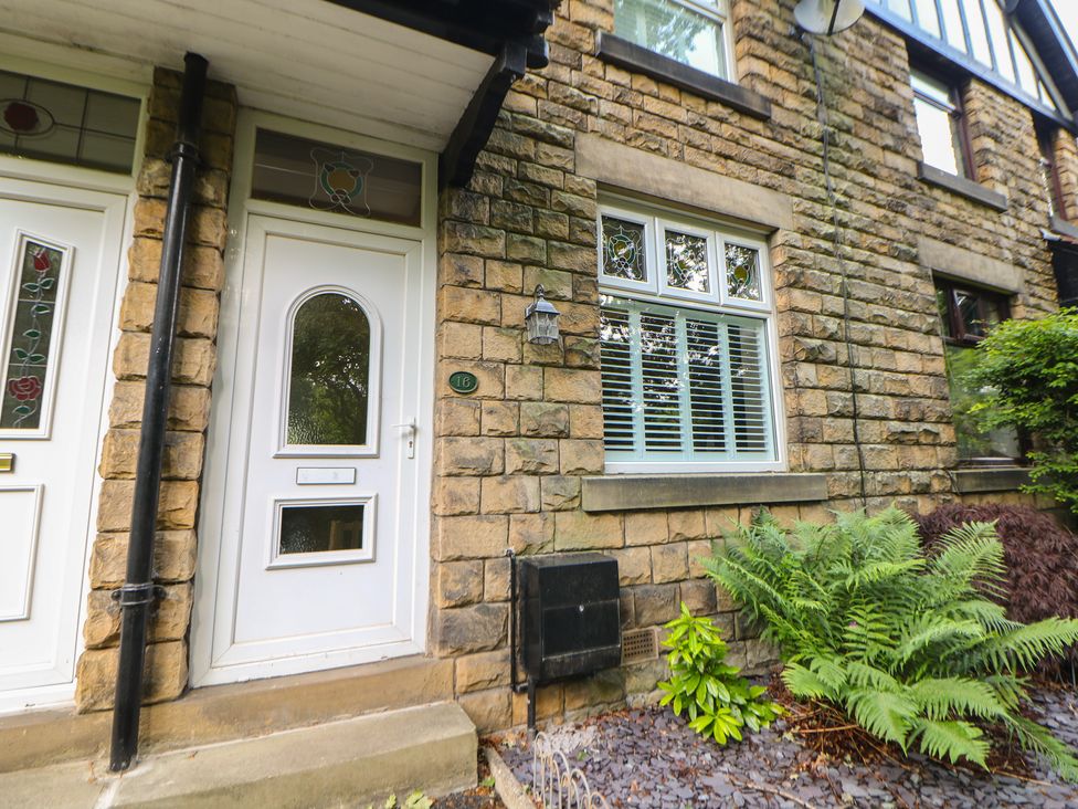 A front door and window with plants at 16 Oak Bank in Stockport