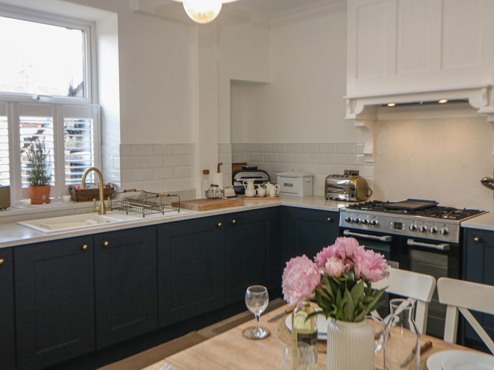 A kitchen with a sink and stove at 16 Oak Bank in Stockport