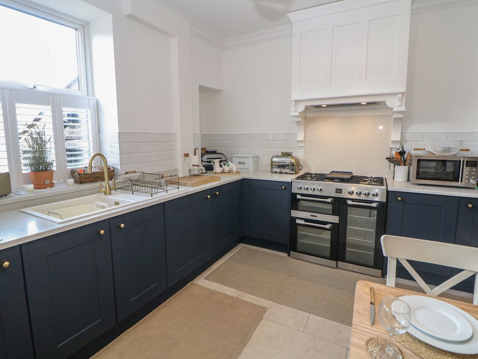 A kitchen with appliances and a sink at 16 Oak Bank in Stockport