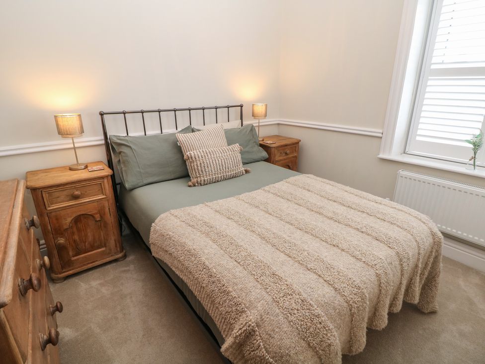 A bedroom with a bed and bedside tables at 16 Oak Bank in Stockport