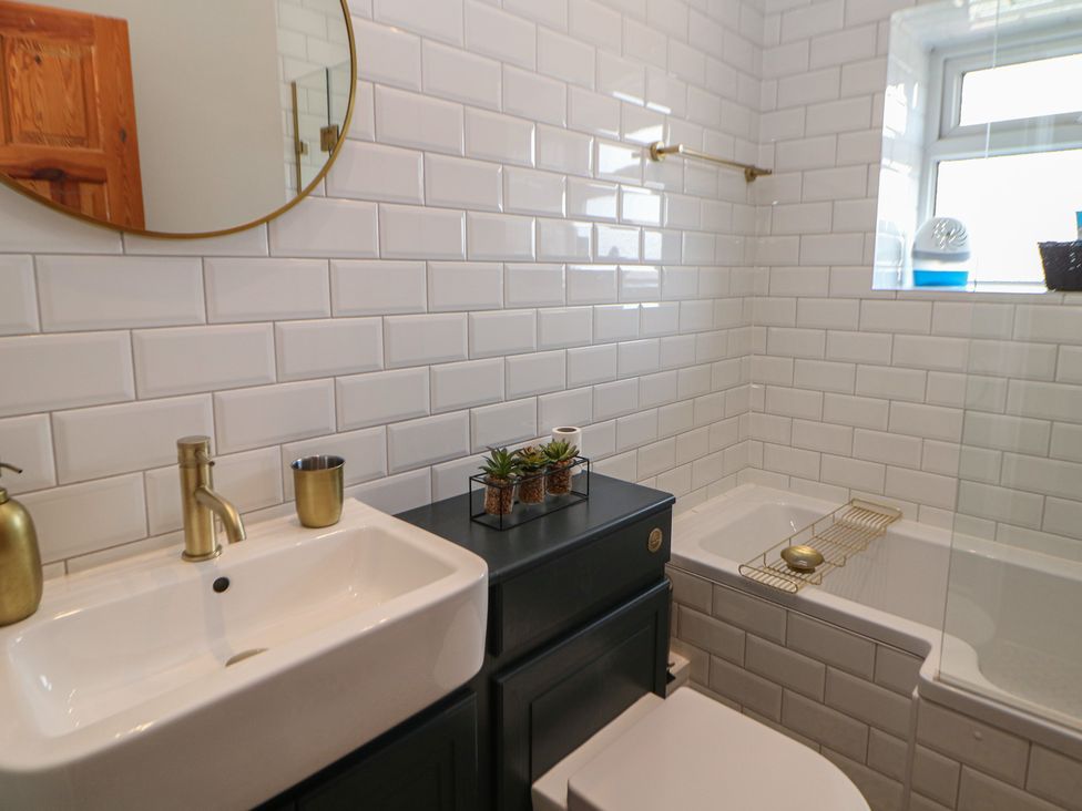A bathroom with a sink, toilet, and bathtub at 16 Oak Bank in Stockport