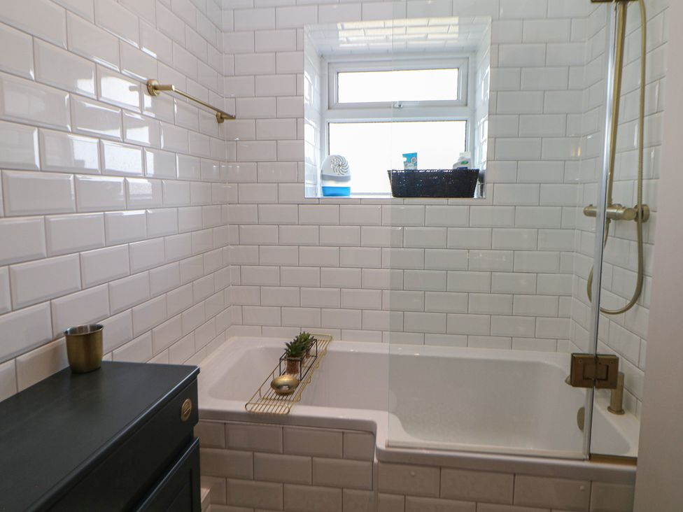 A bathroom with a bathtub and shower at 16 Oak Bank in Stockport