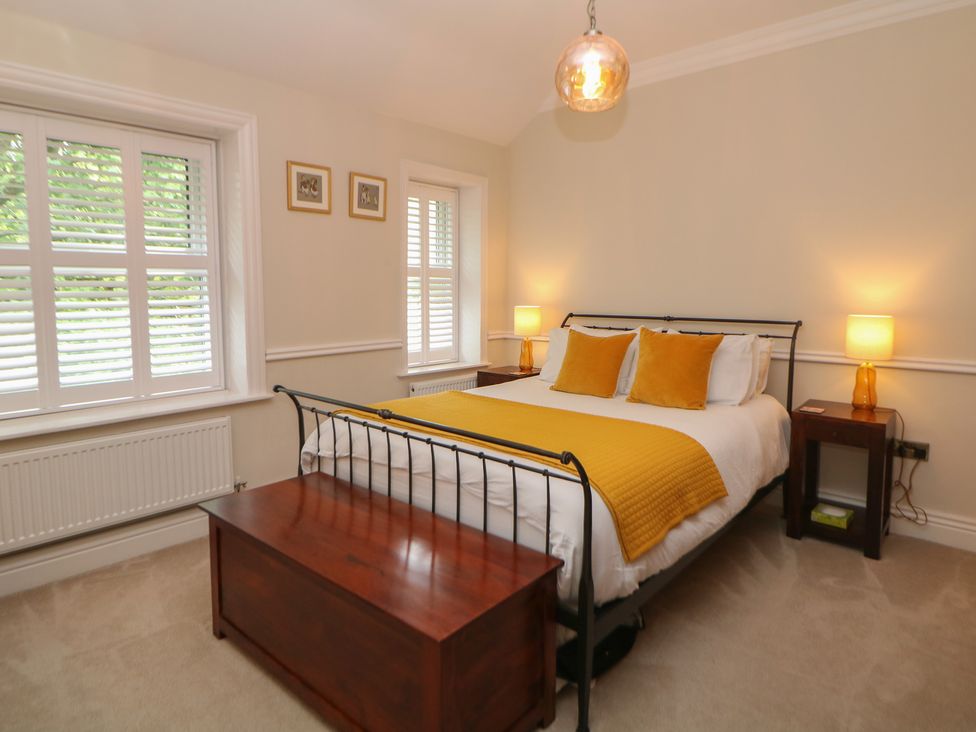 A bedroom with a bed and bedside tables at 16 Oak Bank in Stockport