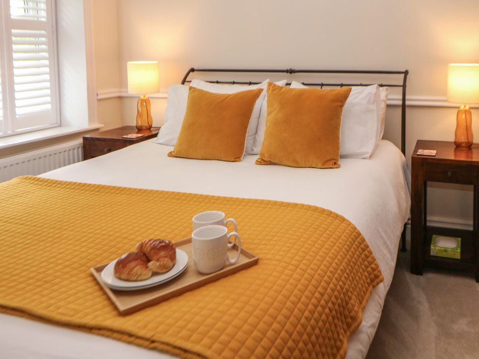 A bedroom with a bed and bedside tables at 16 Oak Bank in Stockport