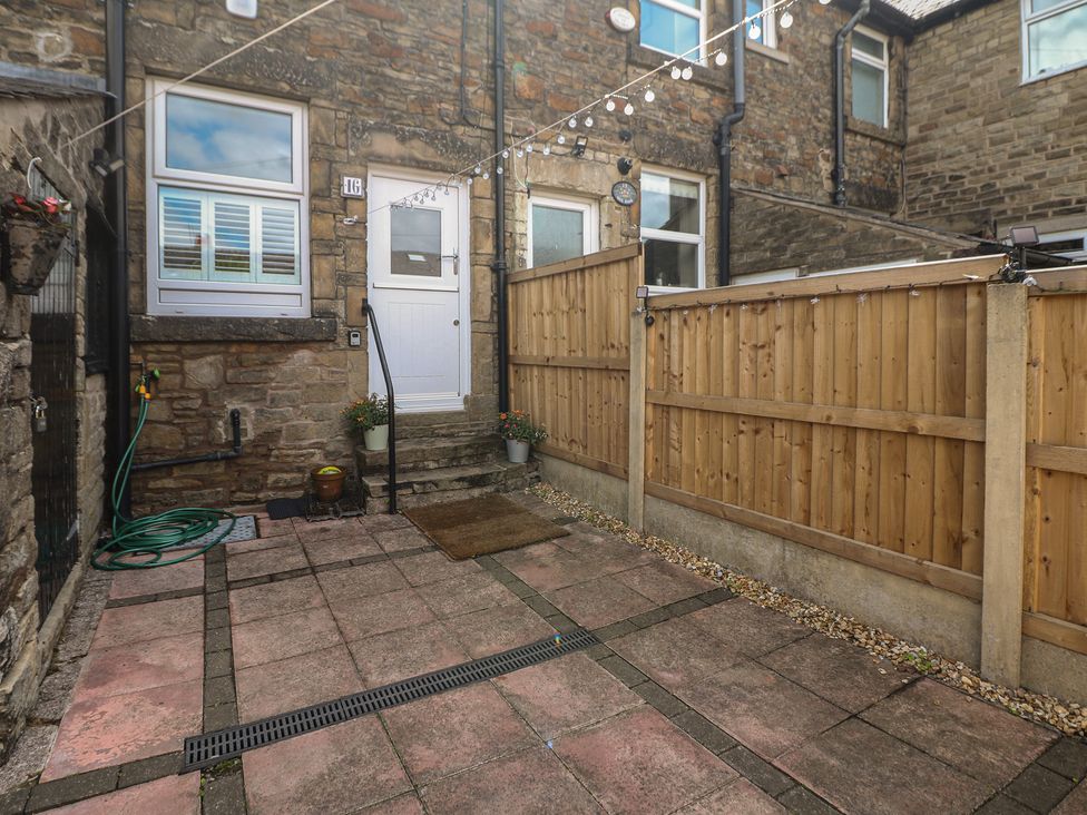 An outdoor area with a door and fence at 16 Oak Bank in Stockport