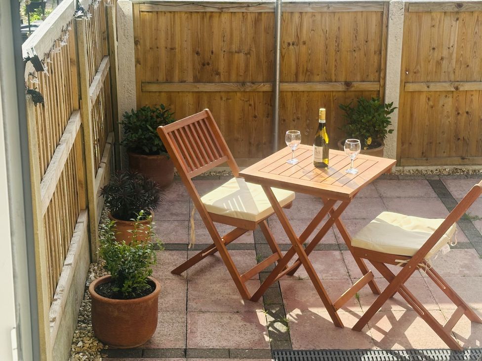 A garden with a table and chairs at 16 Oak Bank in Newtown near New Mills