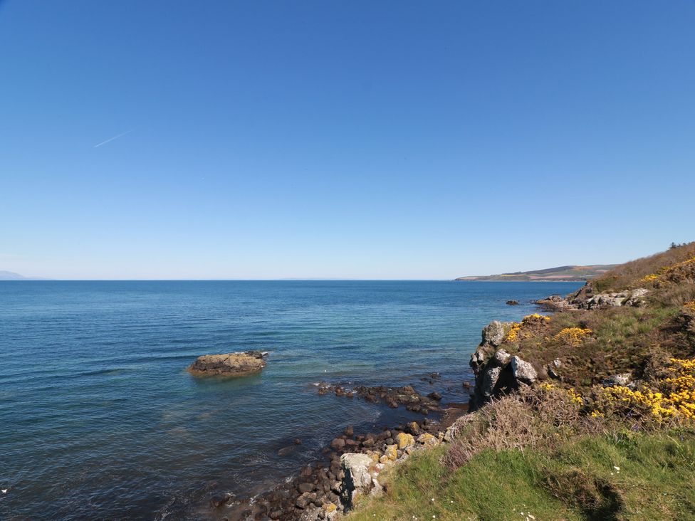 A coastal view with rocks and grass at Rothiemay in Maidens