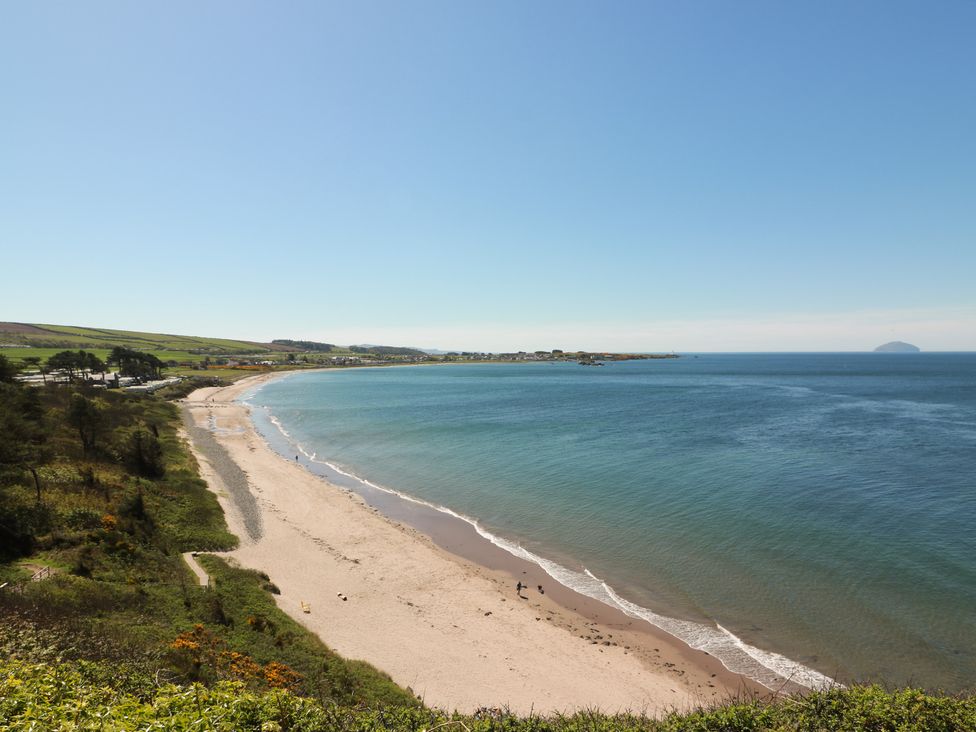 A beach with ocean and hills in the background at Rothiemay in Maidens