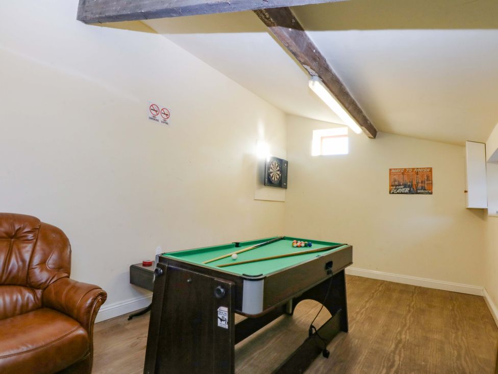 A game room with a pool table and dartboard at Llofft Yr Yd, Porthmadog