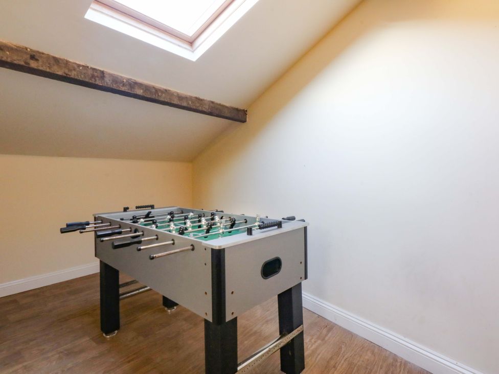A game room with a foosball table at Llofft Yr Yd in Porthmadog