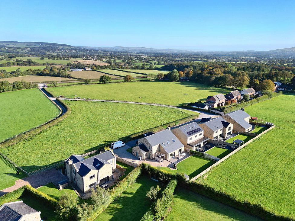 An aerial view of multiple houses and fields at Archstone House in Langho, Lancashire
