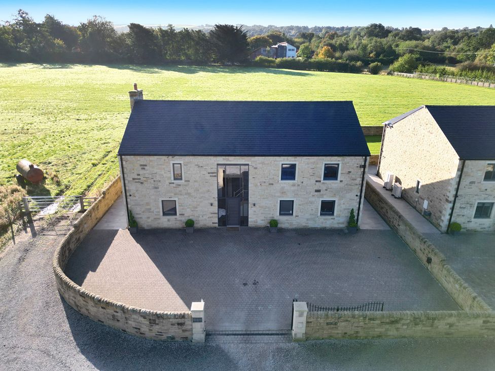 A house with paved driveway and grass area at Archstone House Langho, Lancashire