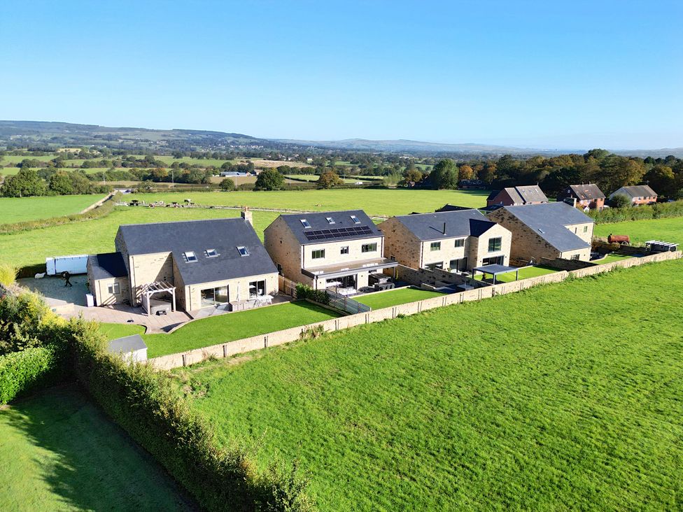 An arrangement of houses with green grass at Archstone House in Langho, Lancashire