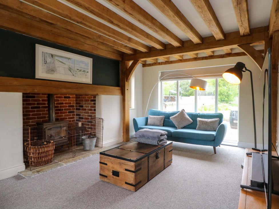 A living room with a fireplace and couch at Gayton Stables in Heswall