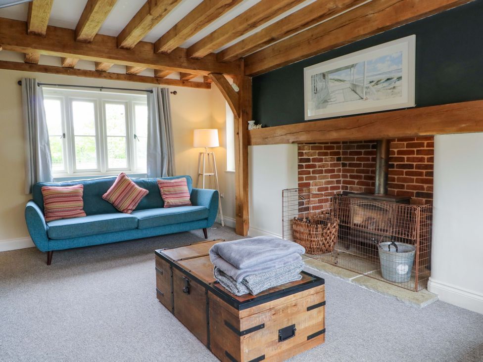 A living room with a sofa and a coffee table at Gayton Stables in Heswall