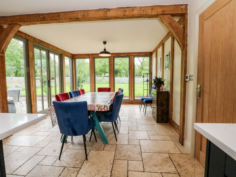 A dining room with a table and chairs at Gayton Stables in Heswall