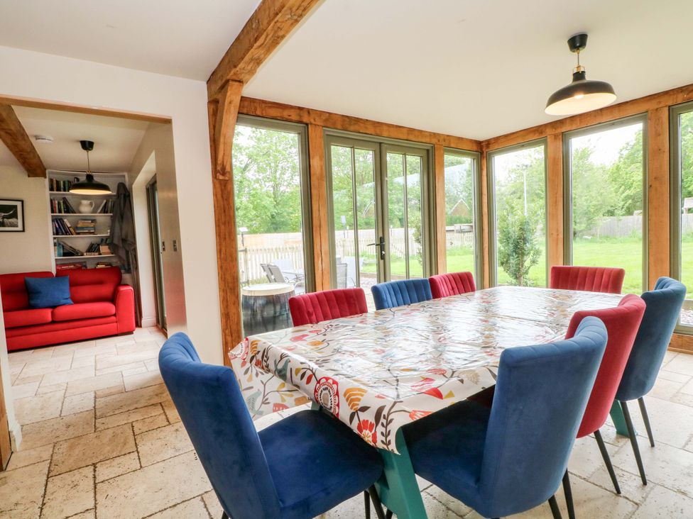 A dining room with a table and chairs visible at Gayton Stables in Heswall