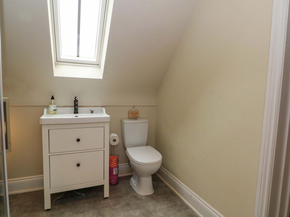 A bathroom with a sink and toilet at Gayton Stables in Heswall