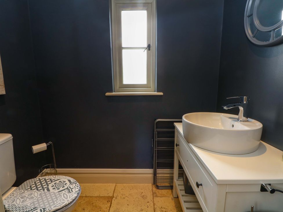 A bathroom with a toilet and hand basin at Gayton Stables in Heswall