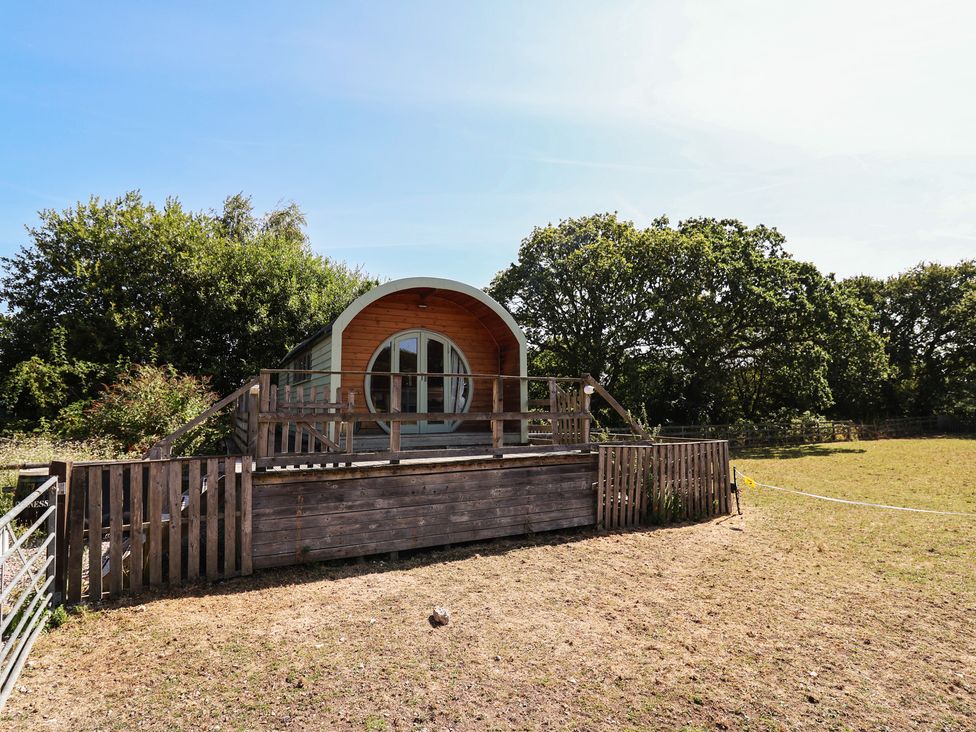 A cabin with a wooden deck in an outdoor area at Gayton Stables in Heswall