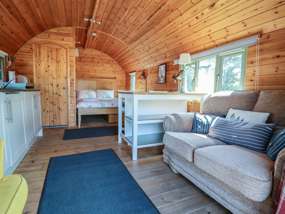 An indoor photo of a living area with a bed and kitchen at Gayton Stables in Heswall