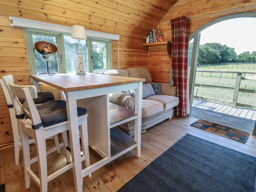 A living room with a table and chairs at Gayton Stables Heswall