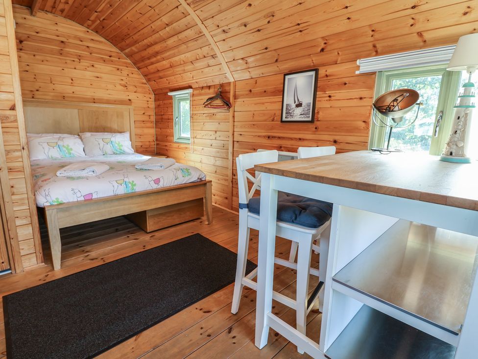A bedroom with a bed and table in Gayton Stables Heswall